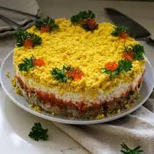Delicious layered cake with yellow frosting and fresh herbs, perfect for microsteading events.
